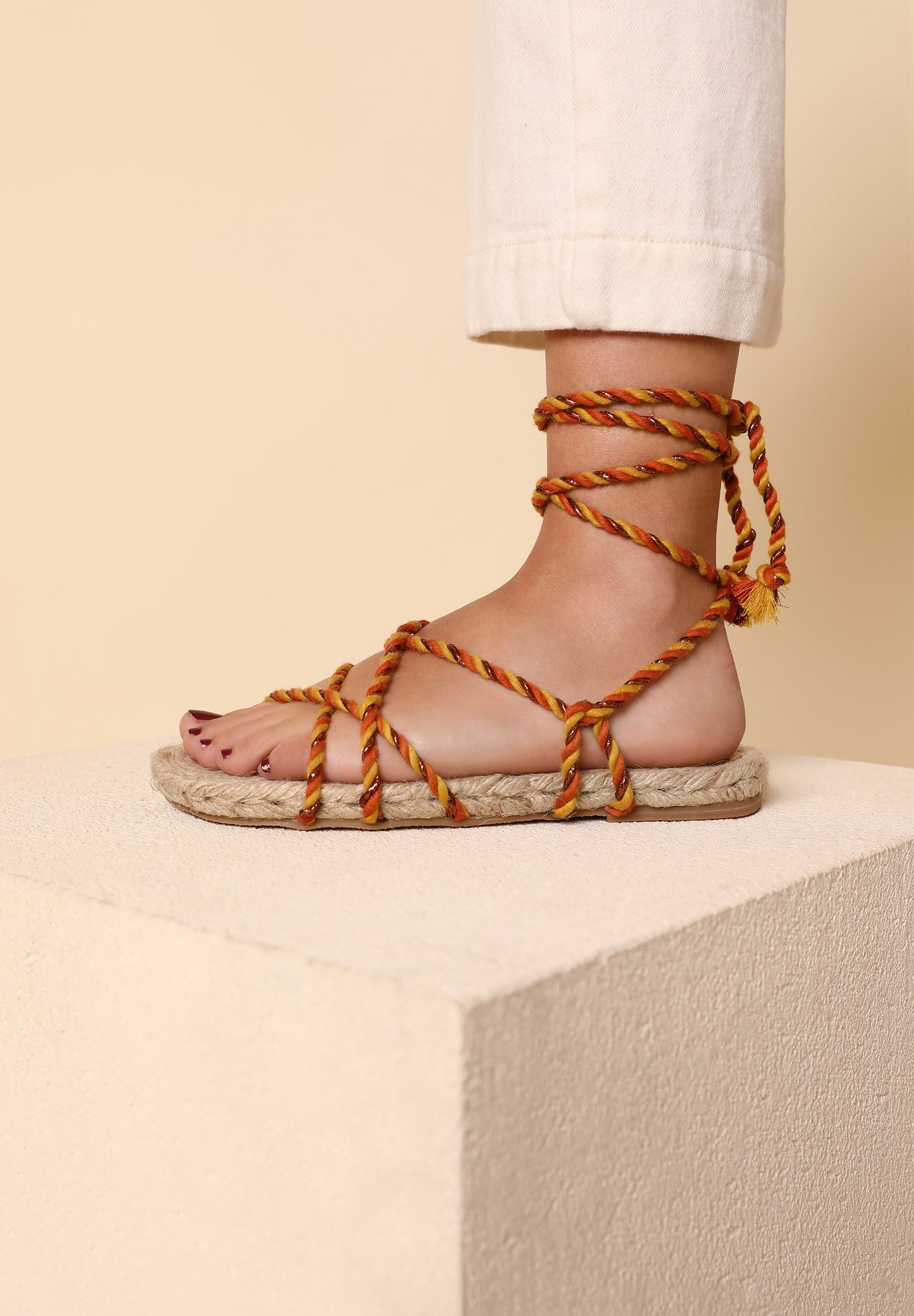 FLAT SANDALS TIED WITH BRAIDED CORDS