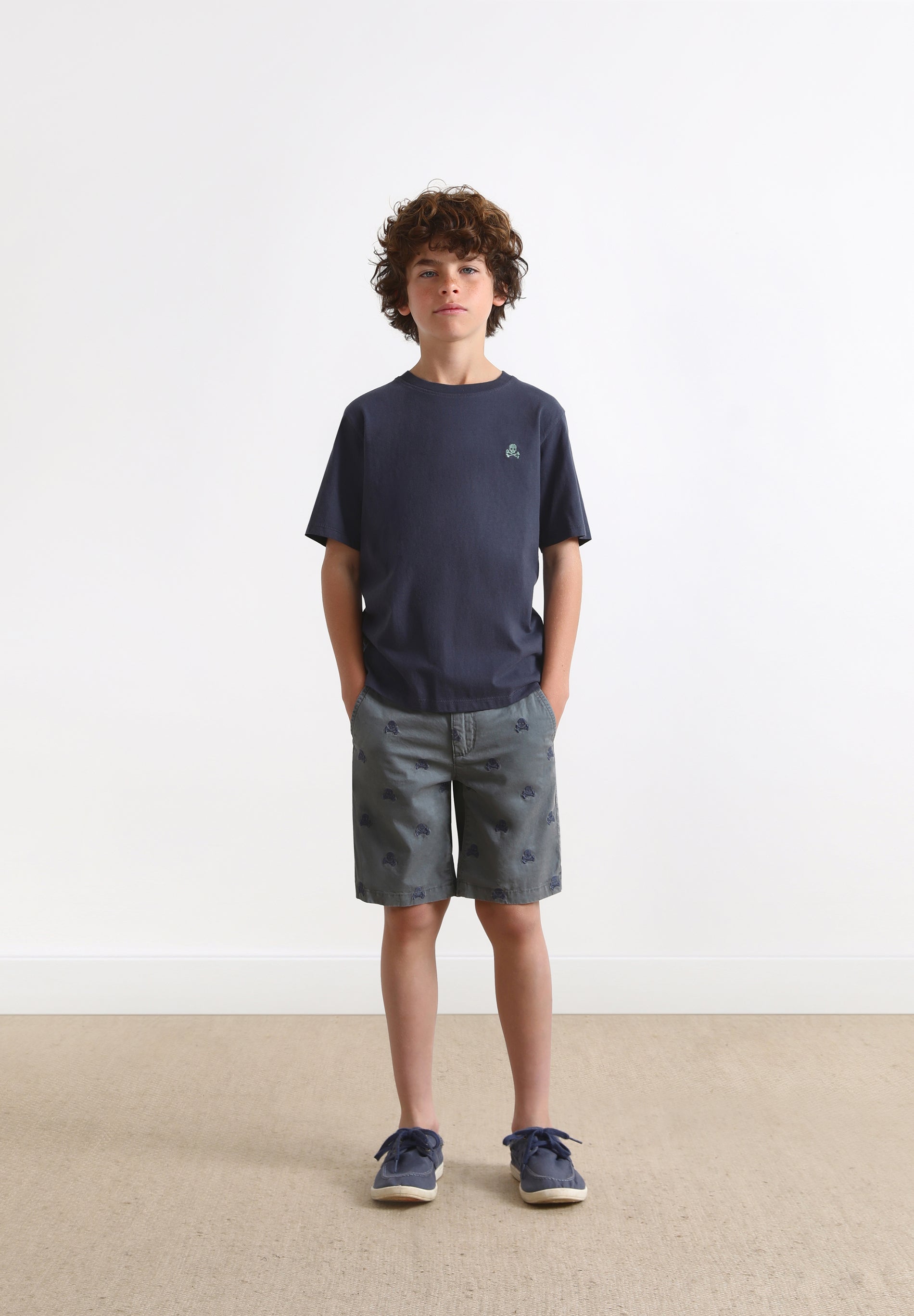 BERMUDA SHORTS WITH ALL-OVER SKULL PRINT