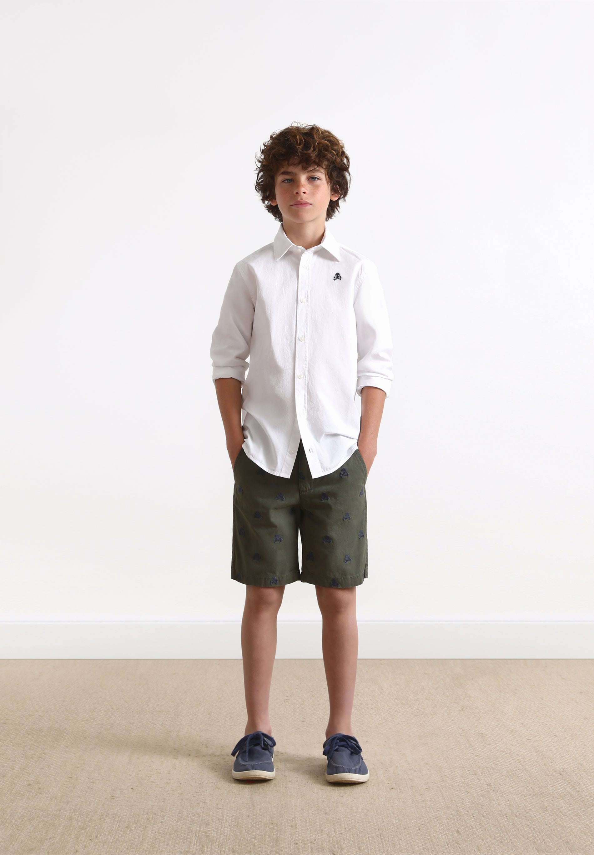 BERMUDA SHORTS WITH ALL-OVER SKULL PRINT