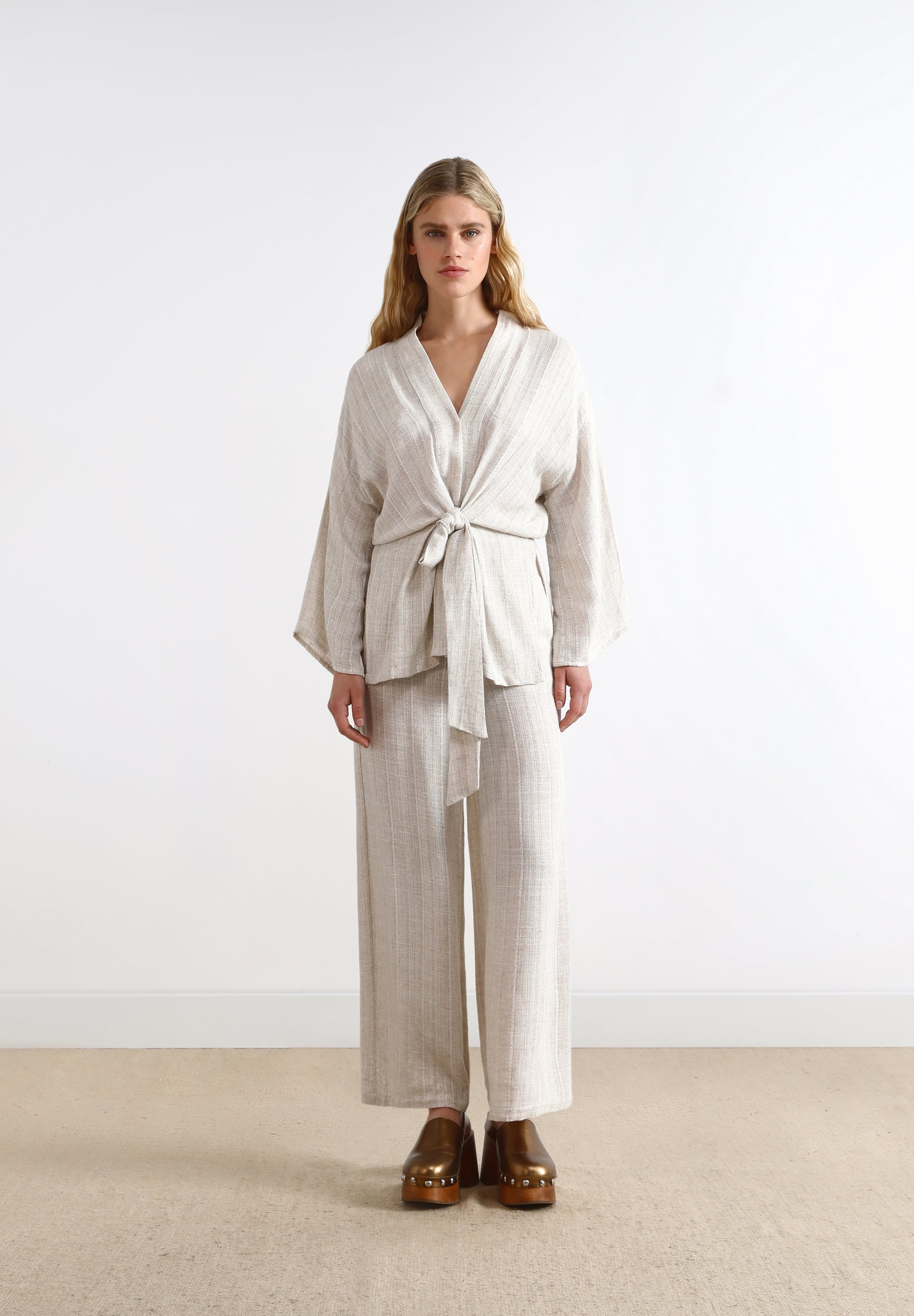 TROUSERS WITH METALLIC DETAILS