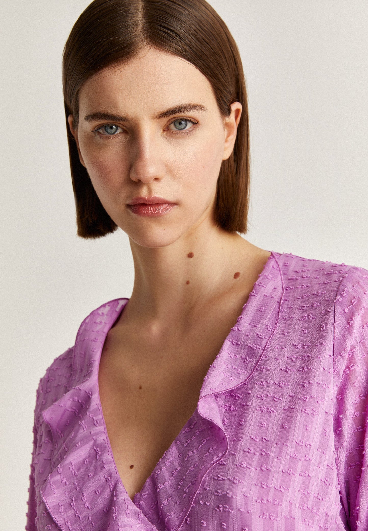 SWISS DOT BLOUSE WITH ASYMMETRIC HEM