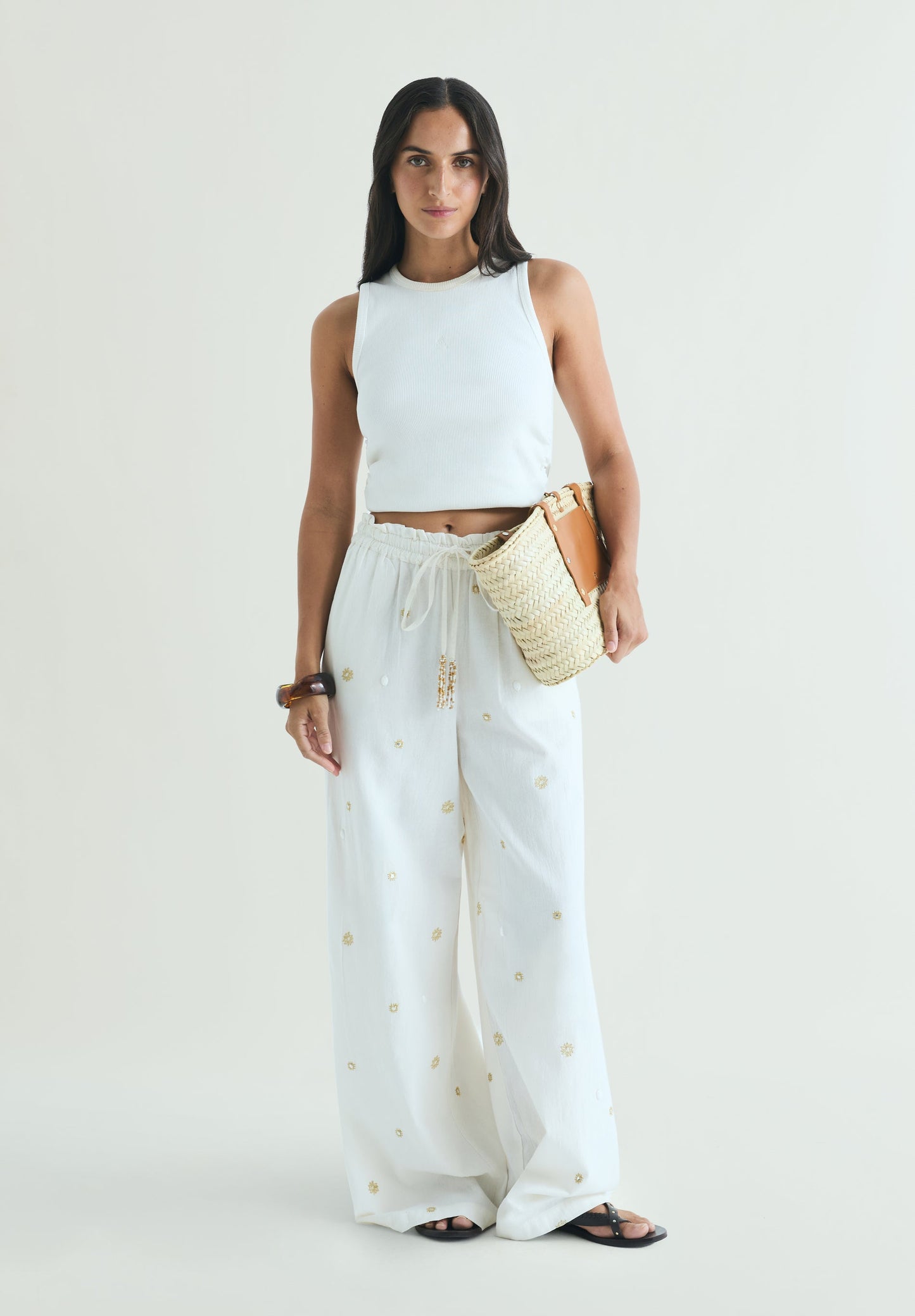 TROUSERS WITH METALLIC DETAILS