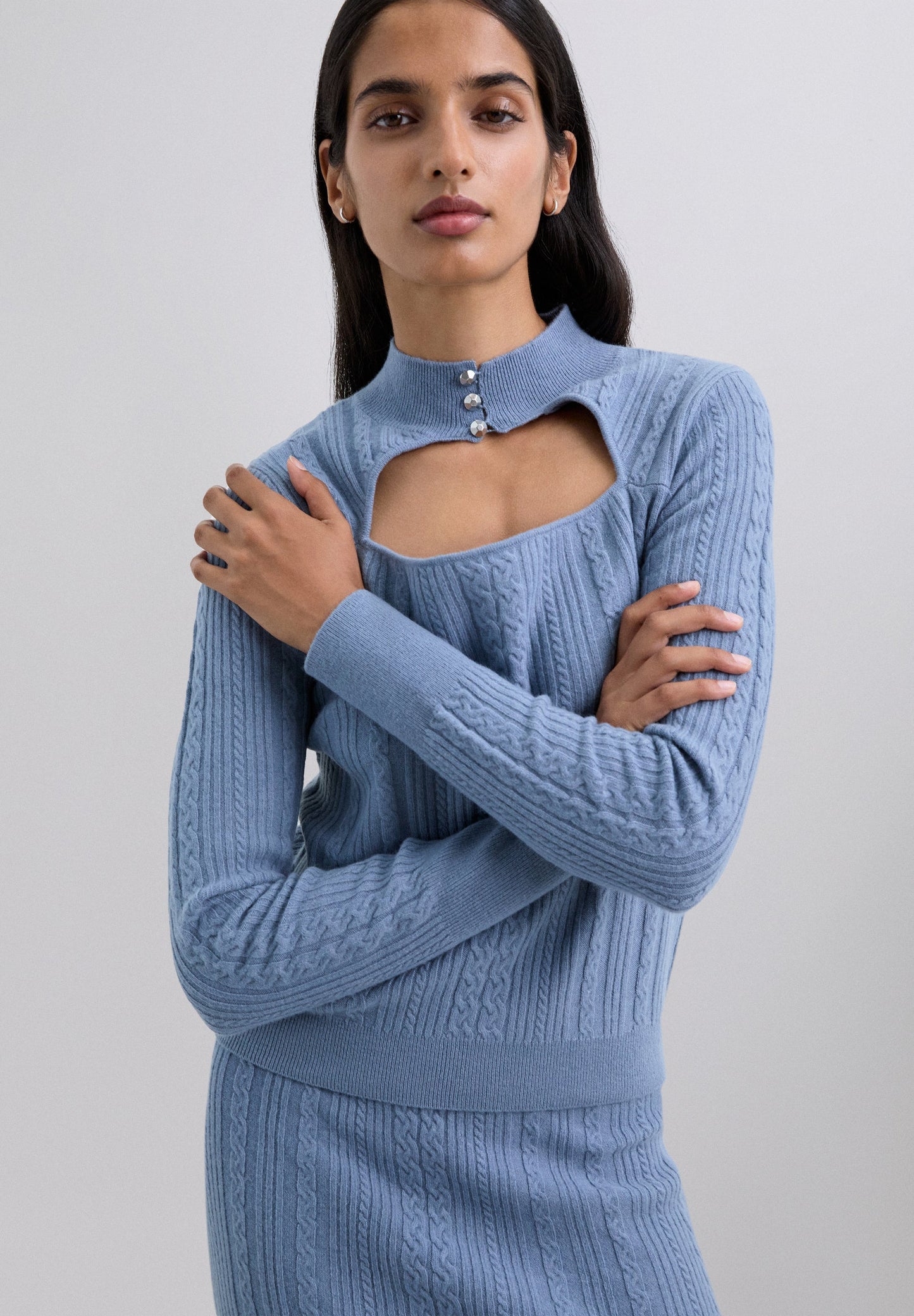 CABLE KNIT SWEATER WITH CUT-OUT