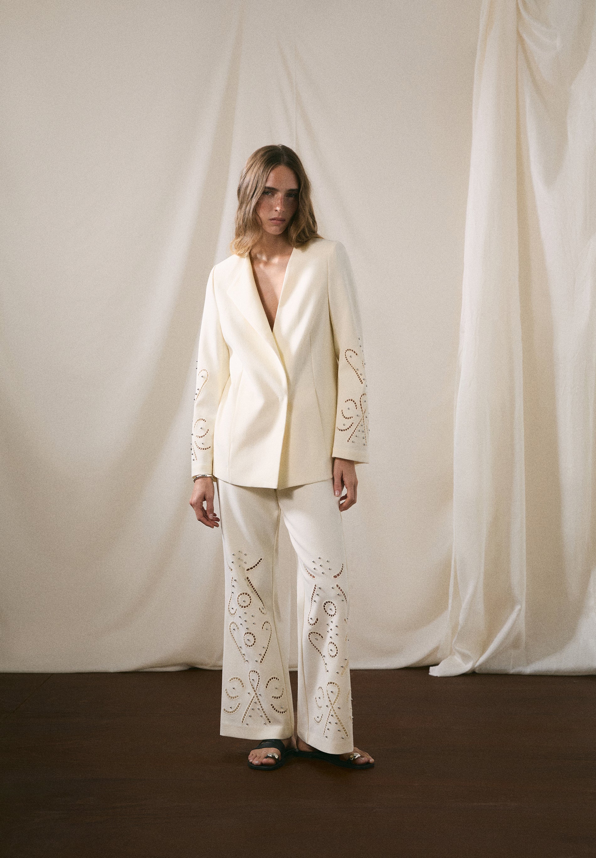 TROUSERS WITH PERFORATED DETAILS